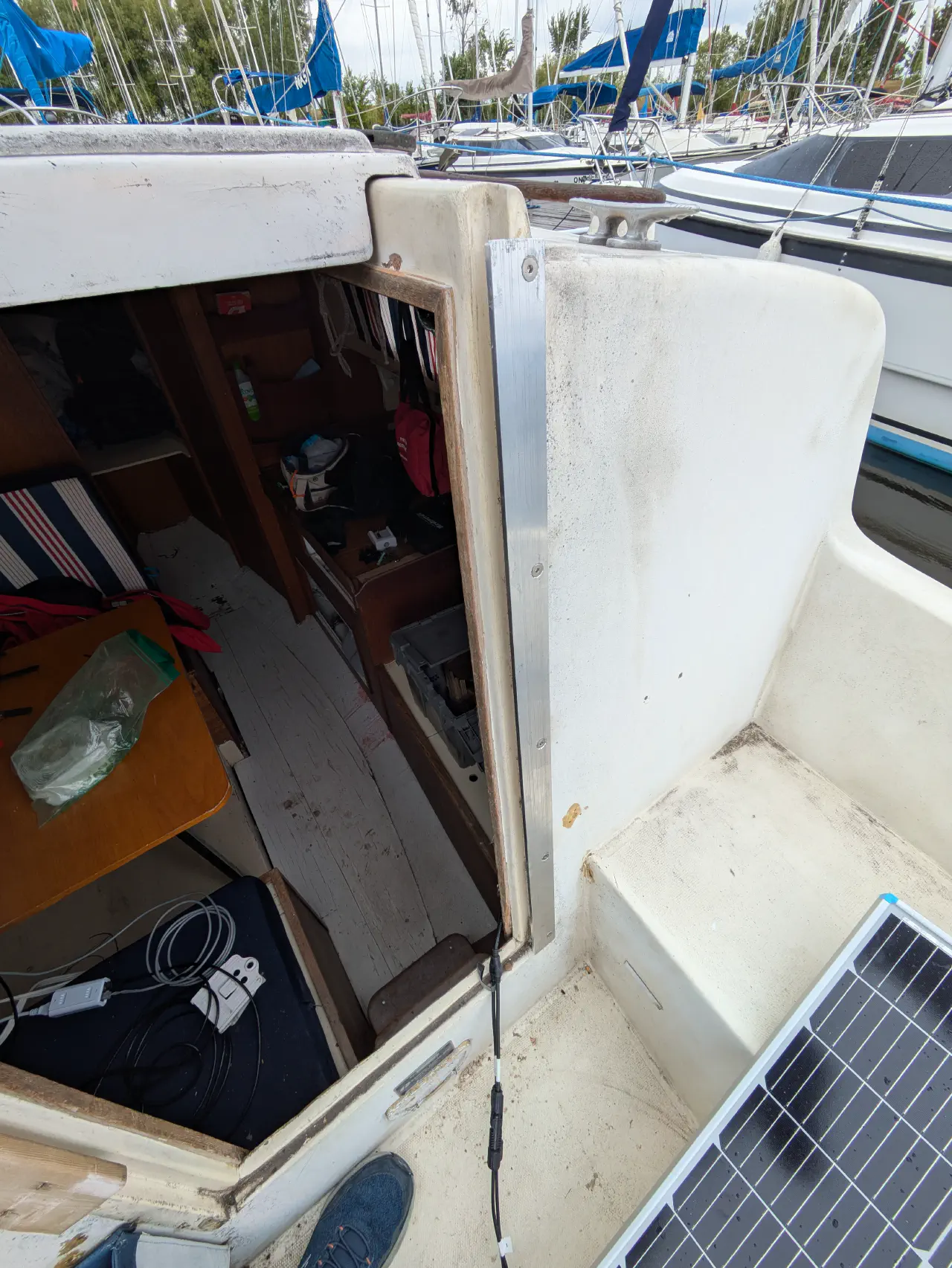 Shiny aluminum bars replace the vertical teak trim around the companionway