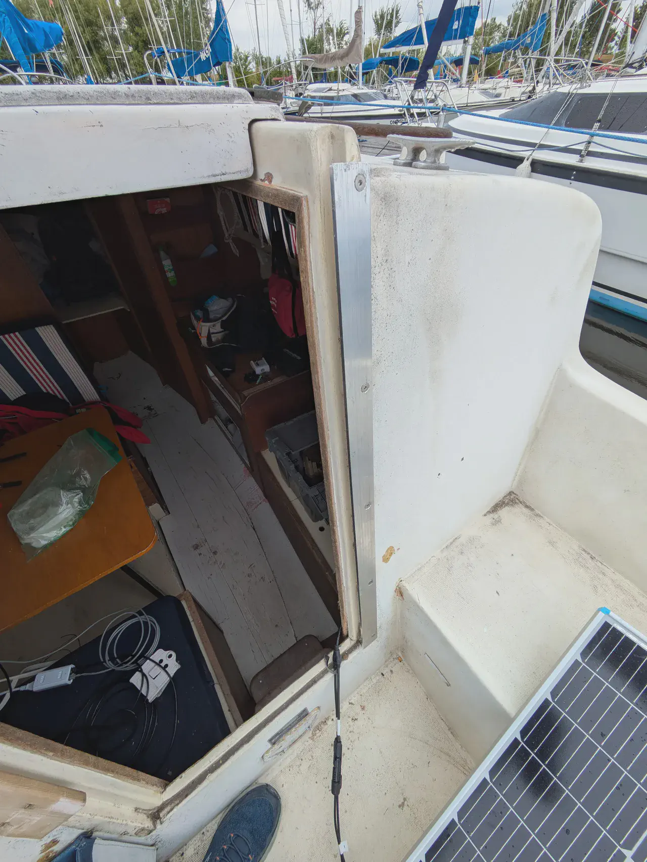 Shiny aluminum bars replace the vertical teak trim around the companionway
